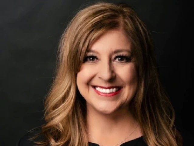 Headshot of Dr. Kasey Urquidez, VP for Enrollment Management and Dean of Admissions.  1990 New Start alumna.